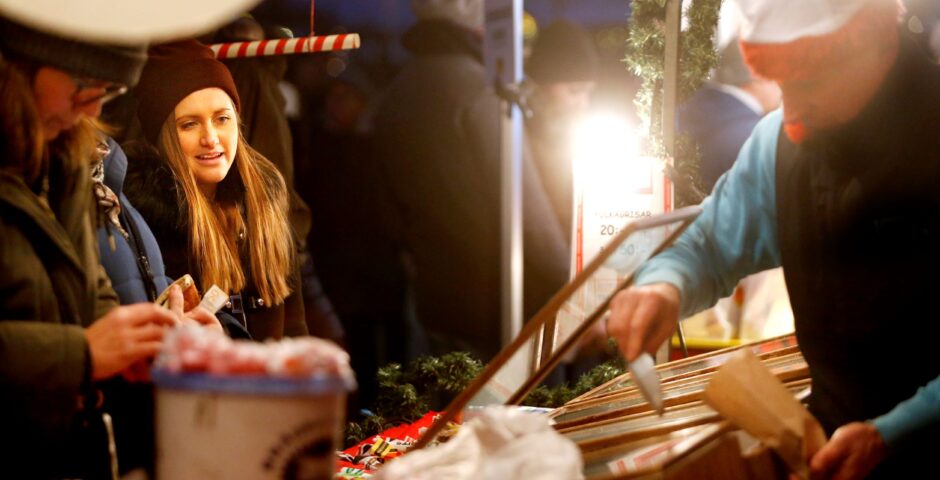 Utställare och besökare på julmarknad.